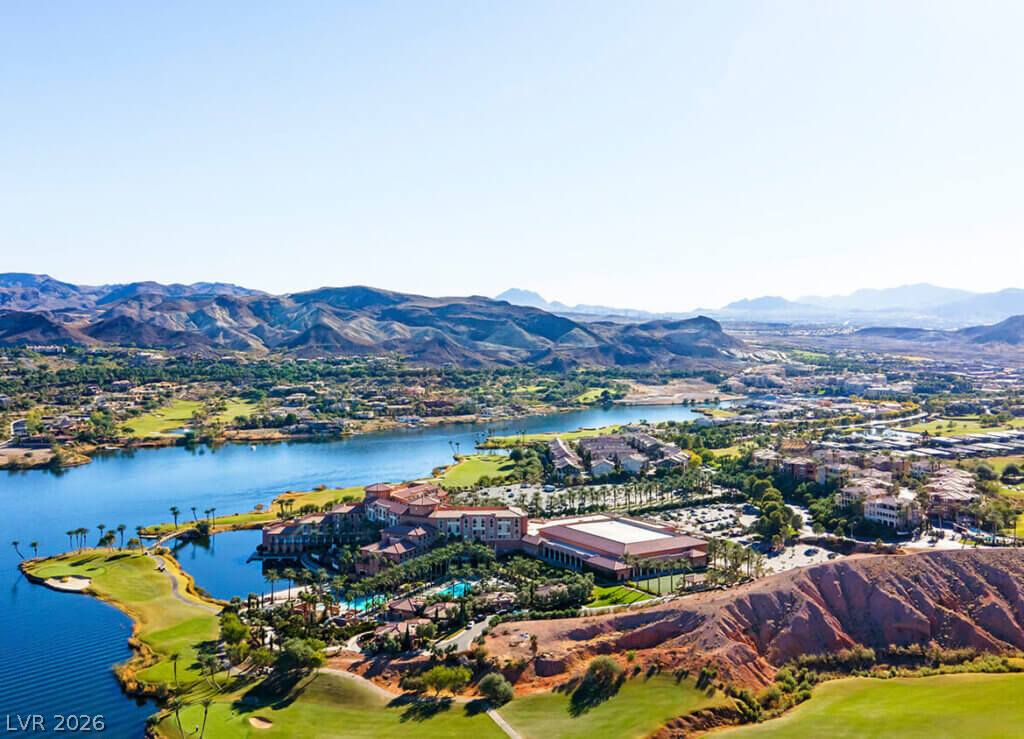 1140 Julie Road Henderson, NV 89002 - Photo 22 of 38 Discover a vibrant community nestled around a tranquil lake, surrounded by verdant golf courses and distant mountains.