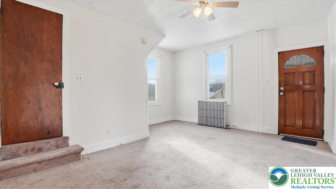 1032 Clamtown Road New Ringgold, PA 17960 - Photo 14 of 68 an empty room with chandelier fan and windows