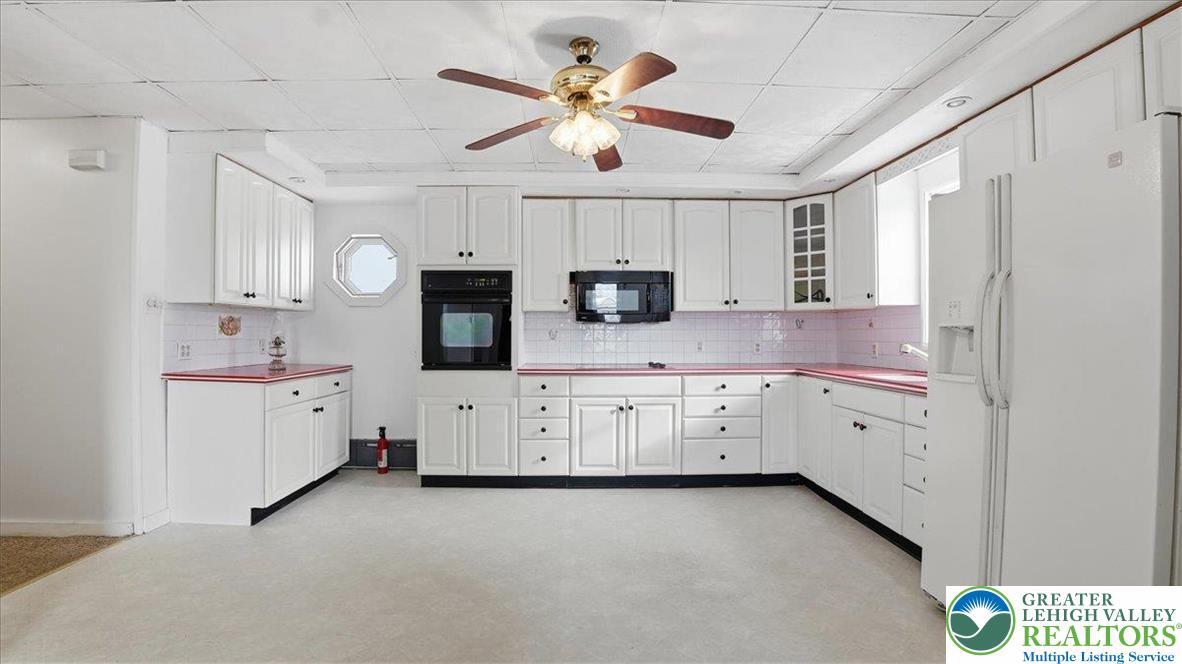 1032 Clamtown Road New Ringgold, PA 17960 - Photo 20 of 68 a kitchen with white cabinets and white appliances