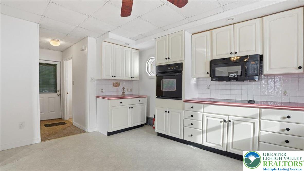 1032 Clamtown Road New Ringgold, PA 17960 - Photo 22 of 68 a kitchen with white cabinets and sink