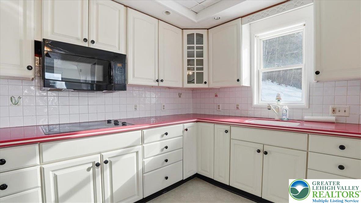 1032 Clamtown Road New Ringgold, PA 17960 - Photo 23 of 68 a kitchen with cabinets appliances a sink and a window