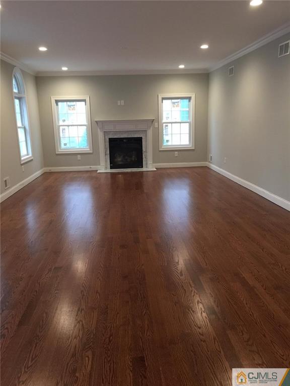 216 Oxford Road Edison, NJ 08820 - Photo 6 of 13 an empty room with windows and fireplace