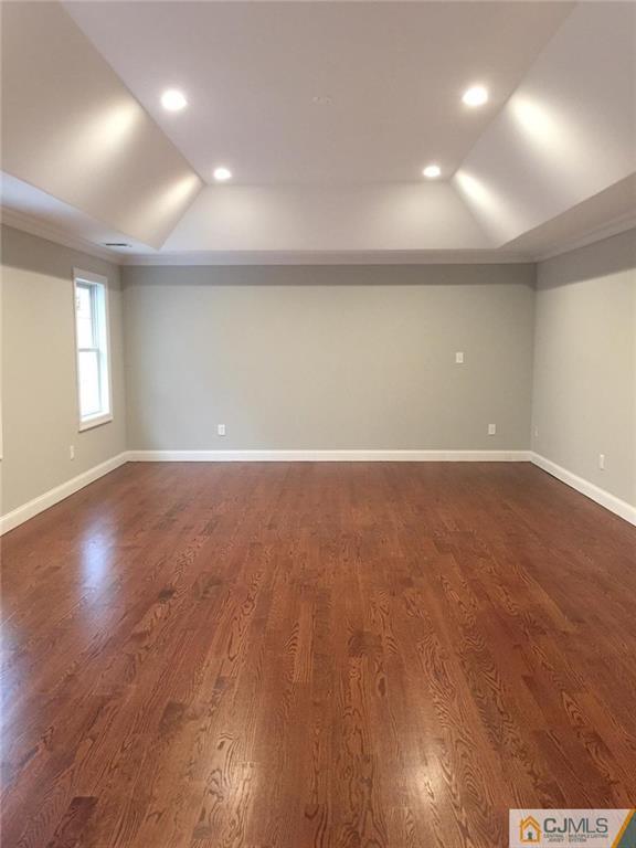 216 Oxford Road Edison, NJ 08820 - Photo 10 of 13 an empty room with wooden floor and windows