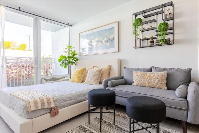 a bedroom with a bed mirror and painting on the wall