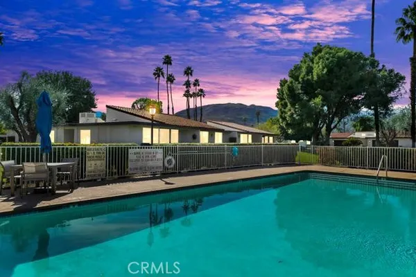 a front view of a house with a yard table and chairs