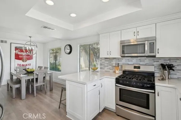a kitchen with stainless steel appliances granite countertop a stove and cabinets
