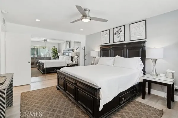 a large bedroom with a bed and a chandelier