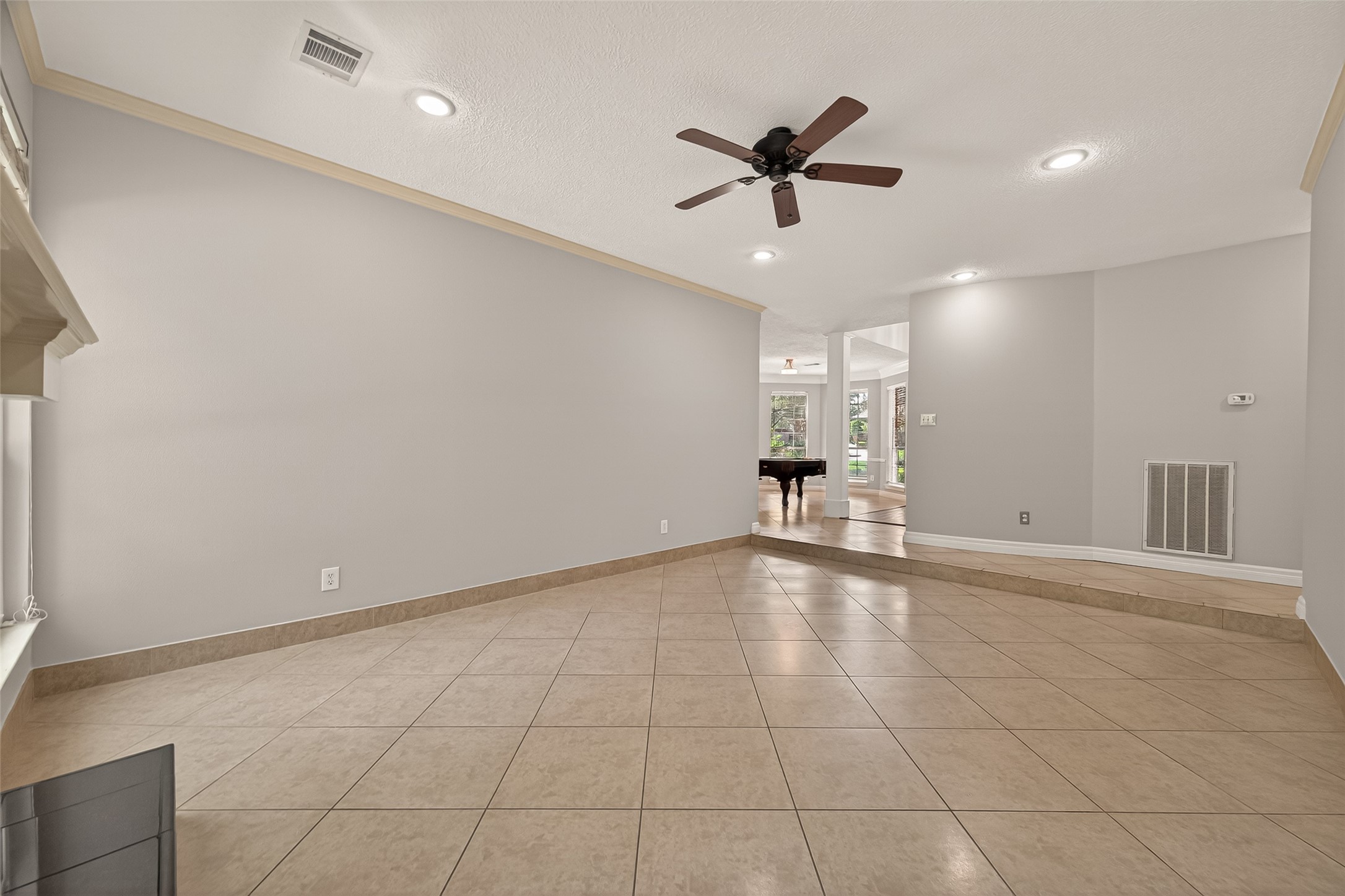 6131 Hampton Way Court Spring, TX 77389 - Photo 12 of 50 a view of empty room with wooden floor and ceiling fan