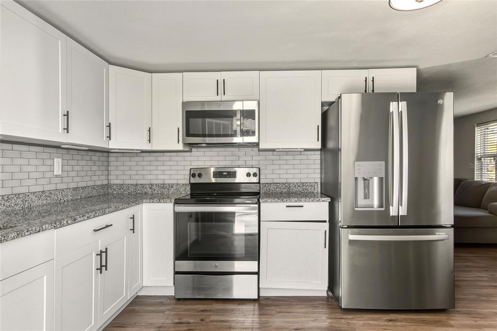 3210 Decatur Avenue Lakeland, FL 33805 - Photo 11 of 37 a kitchen with cabinets stainless steel appliances and a counter space