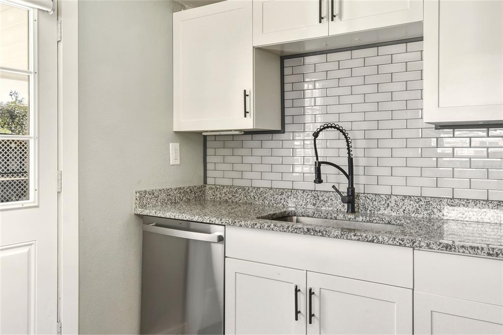 3210 Decatur Avenue Lakeland, FL 33805 - Photo 13 of 37 a kitchen with granite countertop white cabinets and a sink