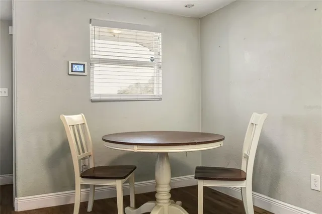 a dining room with furniture and window