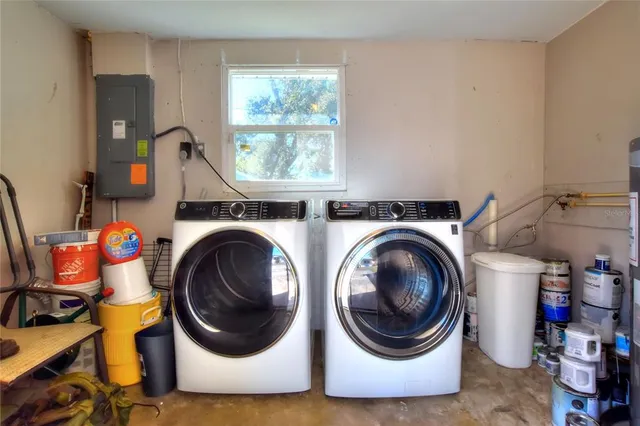 a utility room with dryer washer and a window