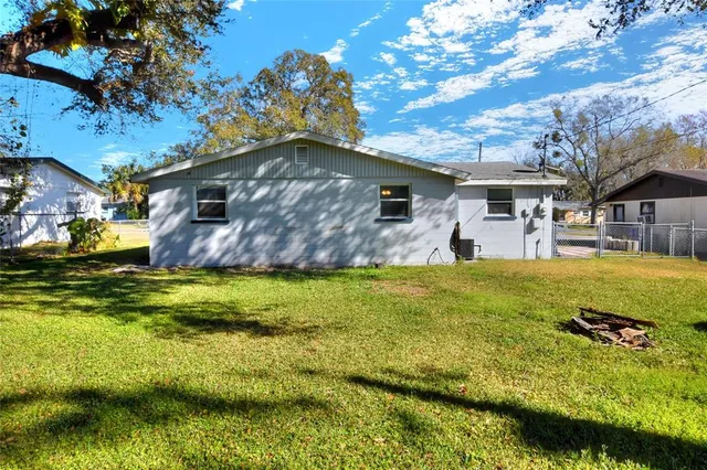 a front view of house with yard and swimming pool