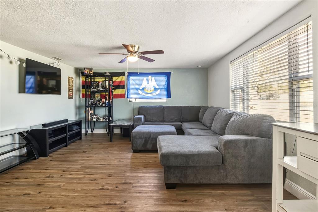 3210 Decatur Avenue Lakeland, FL 33805 - Photo 6 of 37 a living room with furniture flat screen tv and a window