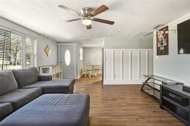 a living room with furniture and wooden floor