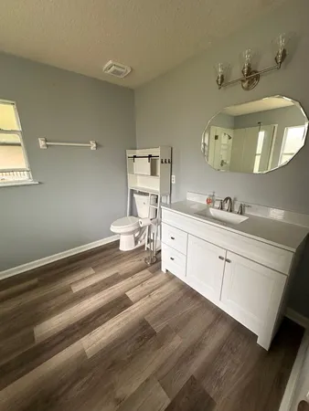 a spacious bathroom with a double vanity sink and a mirror