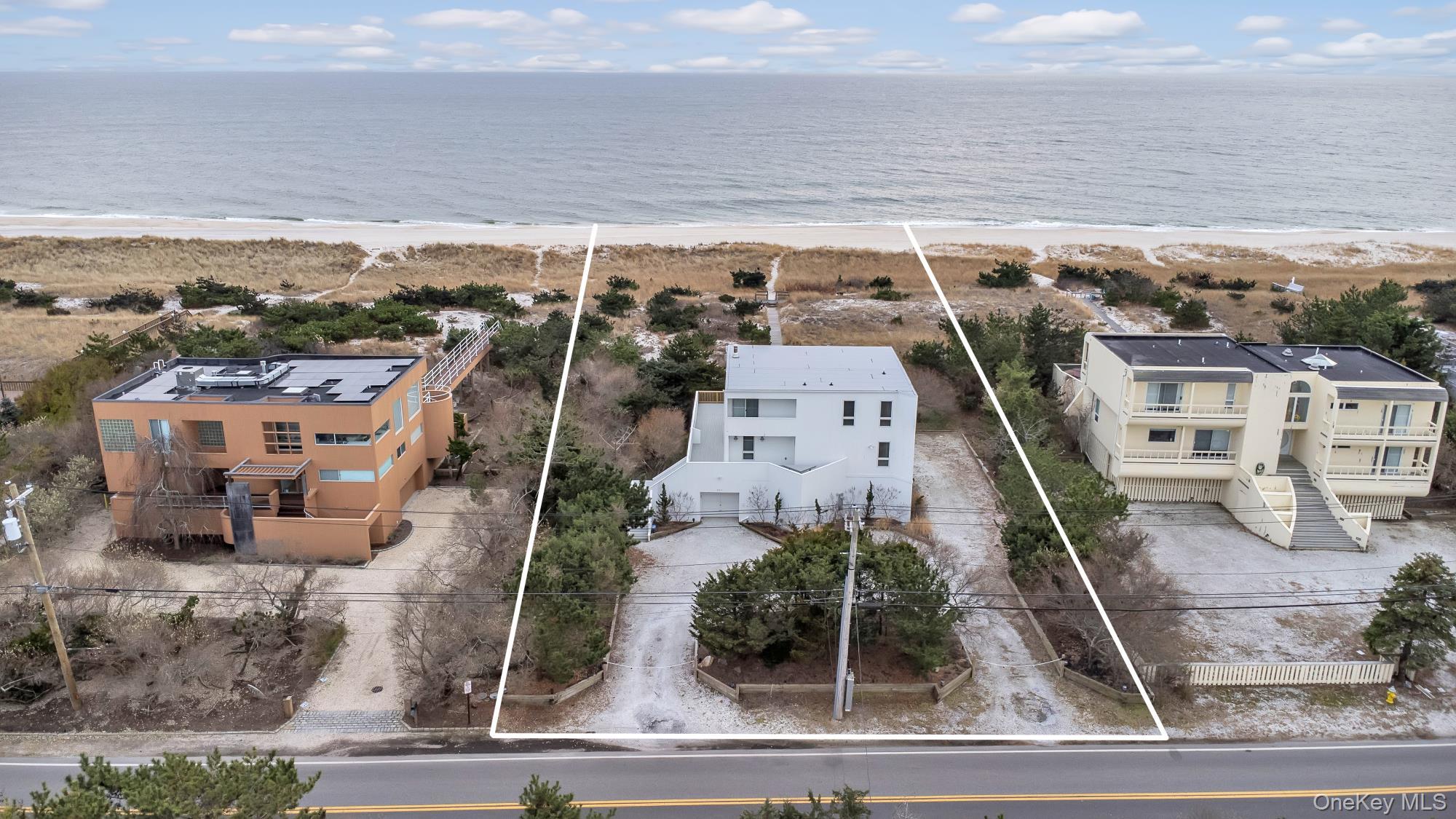 561 Dune Road Westhampton, NY 11978 - Photo 1 of 8 Drone / aerial view with a water view and a view of the beach