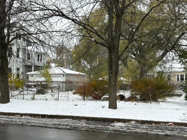 a view of a house with a yard covered in snow