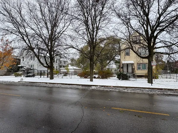 a view of a house with a yard covered with snow