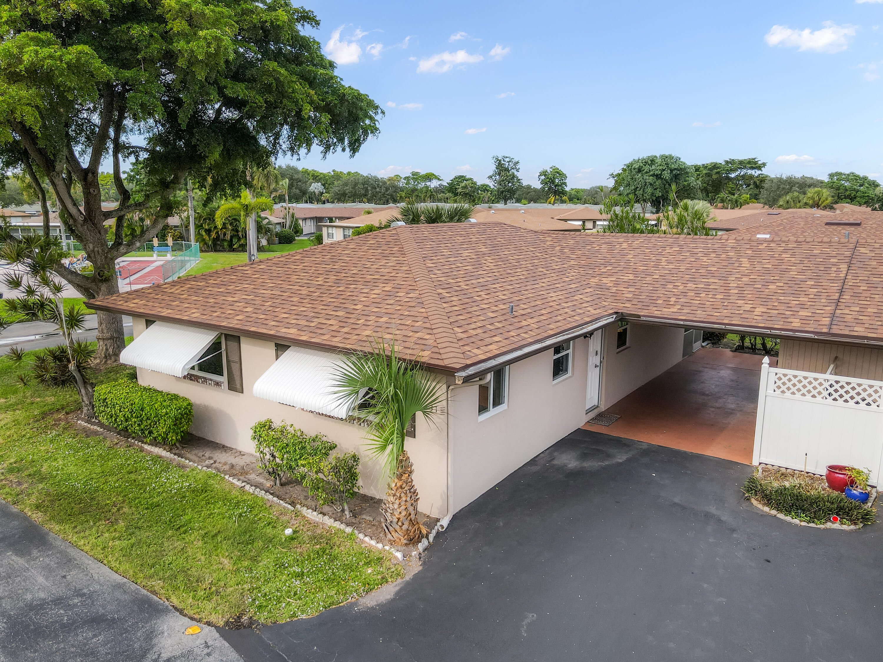 131 Mockingbird Lane Delray Beach, FL 33445 - Photo 2 of 29 an aerial view of a house with a yard and potted plants