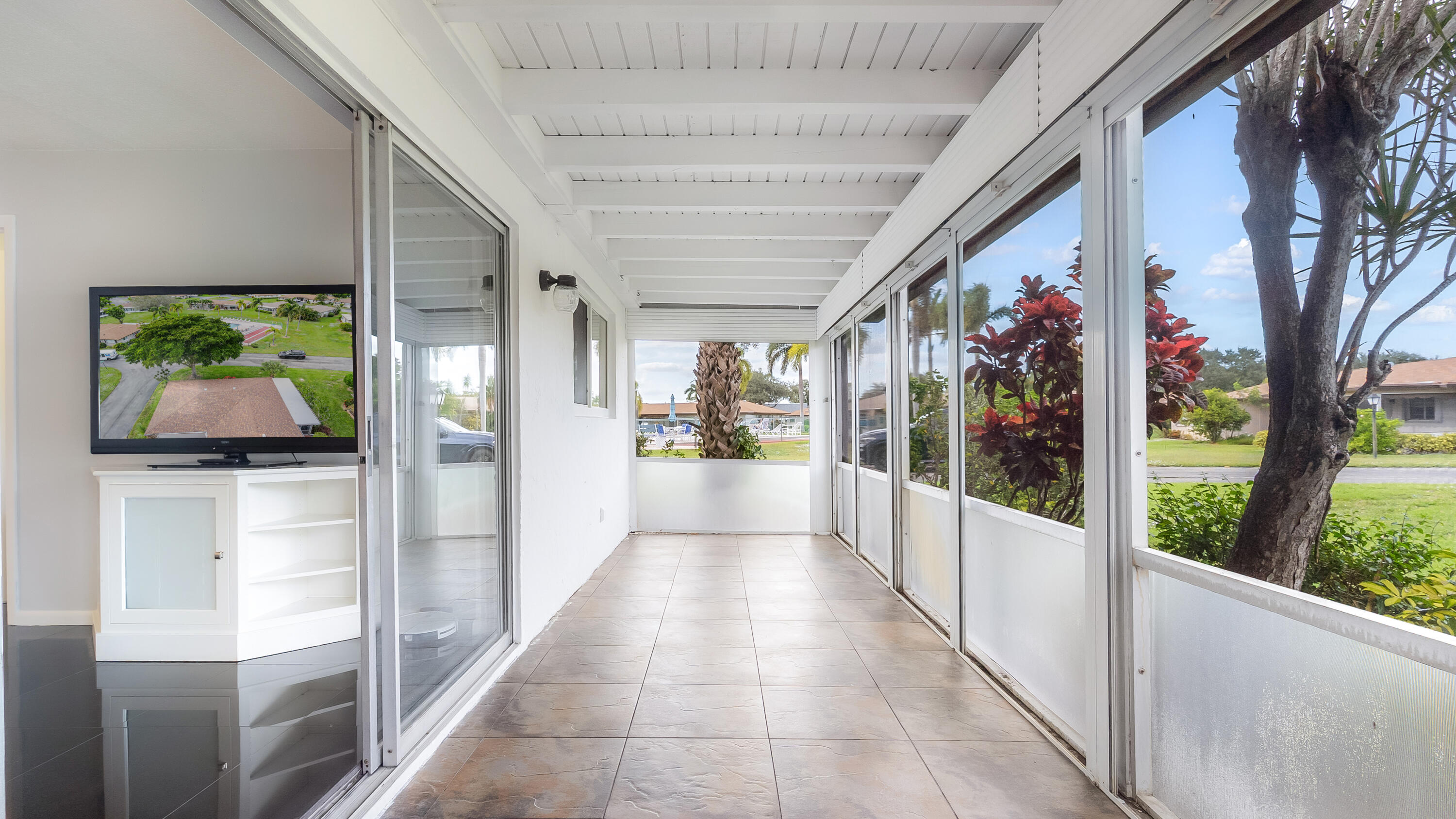 131 Mockingbird Lane Delray Beach, FL 33445 - Photo 26 of 29 a hallway with a dining table and chairs