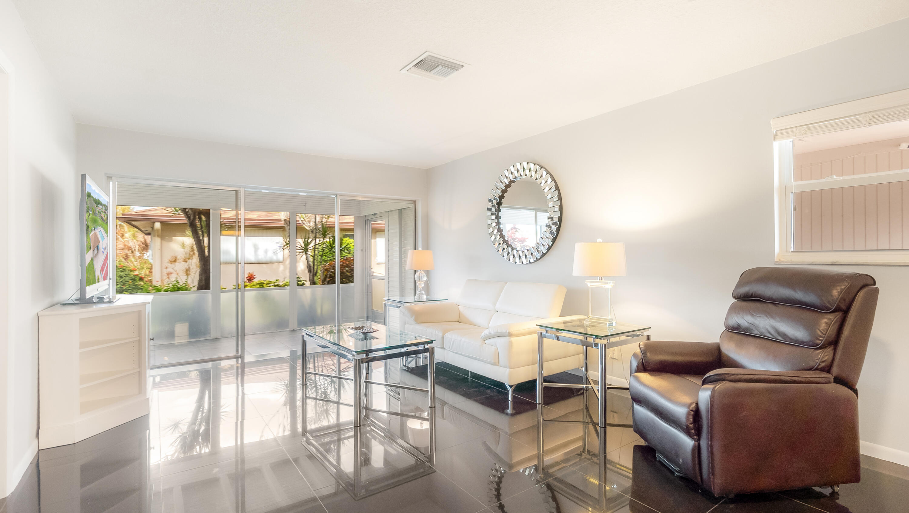 131 Mockingbird Lane Delray Beach, FL 33445 - Photo 3 of 29 a living room with furniture and a large window