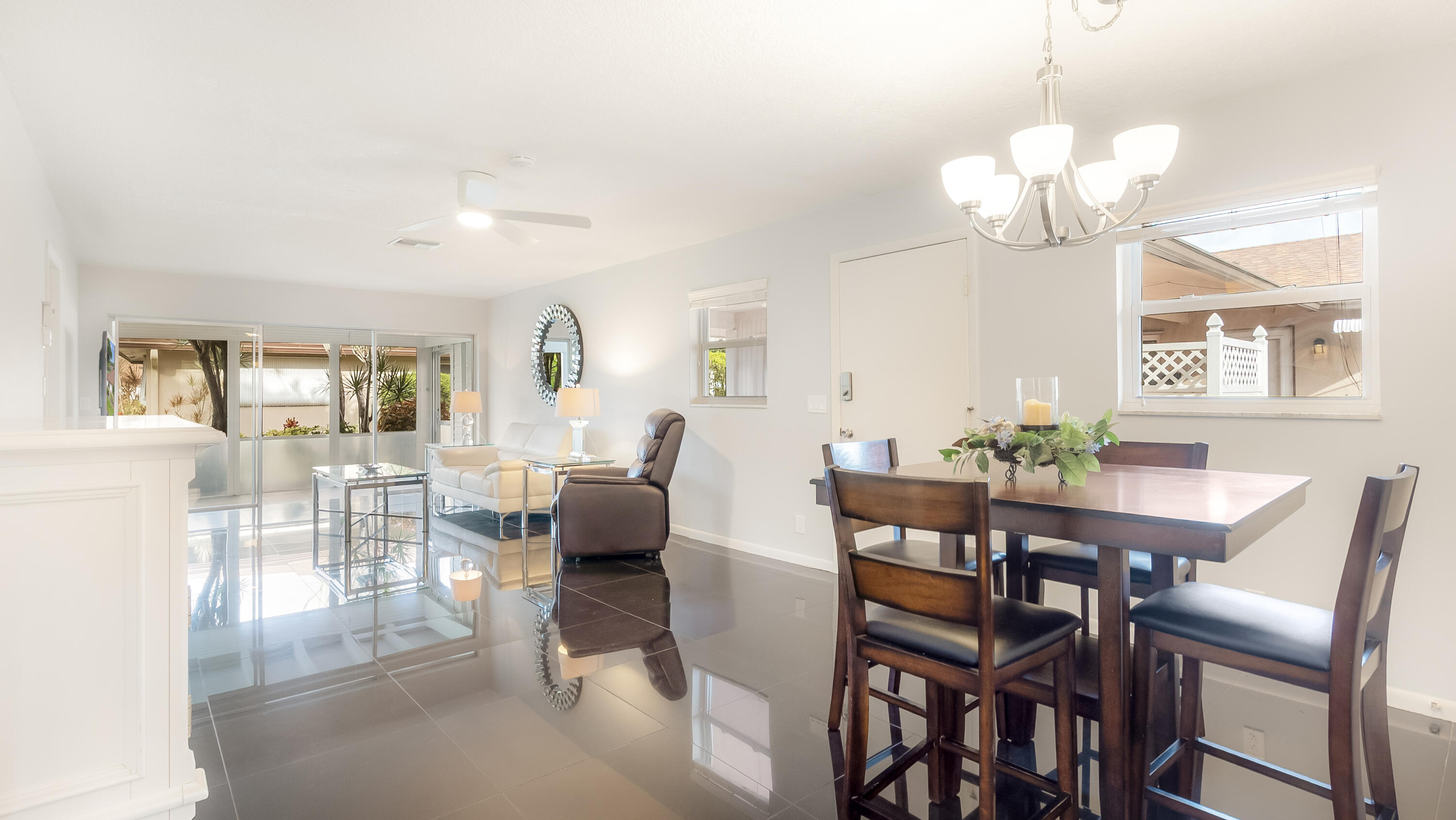 131 Mockingbird Lane Delray Beach, FL 33445 - Photo 6 of 29 a view of a dining room with furniture a chandelier and wooden floor