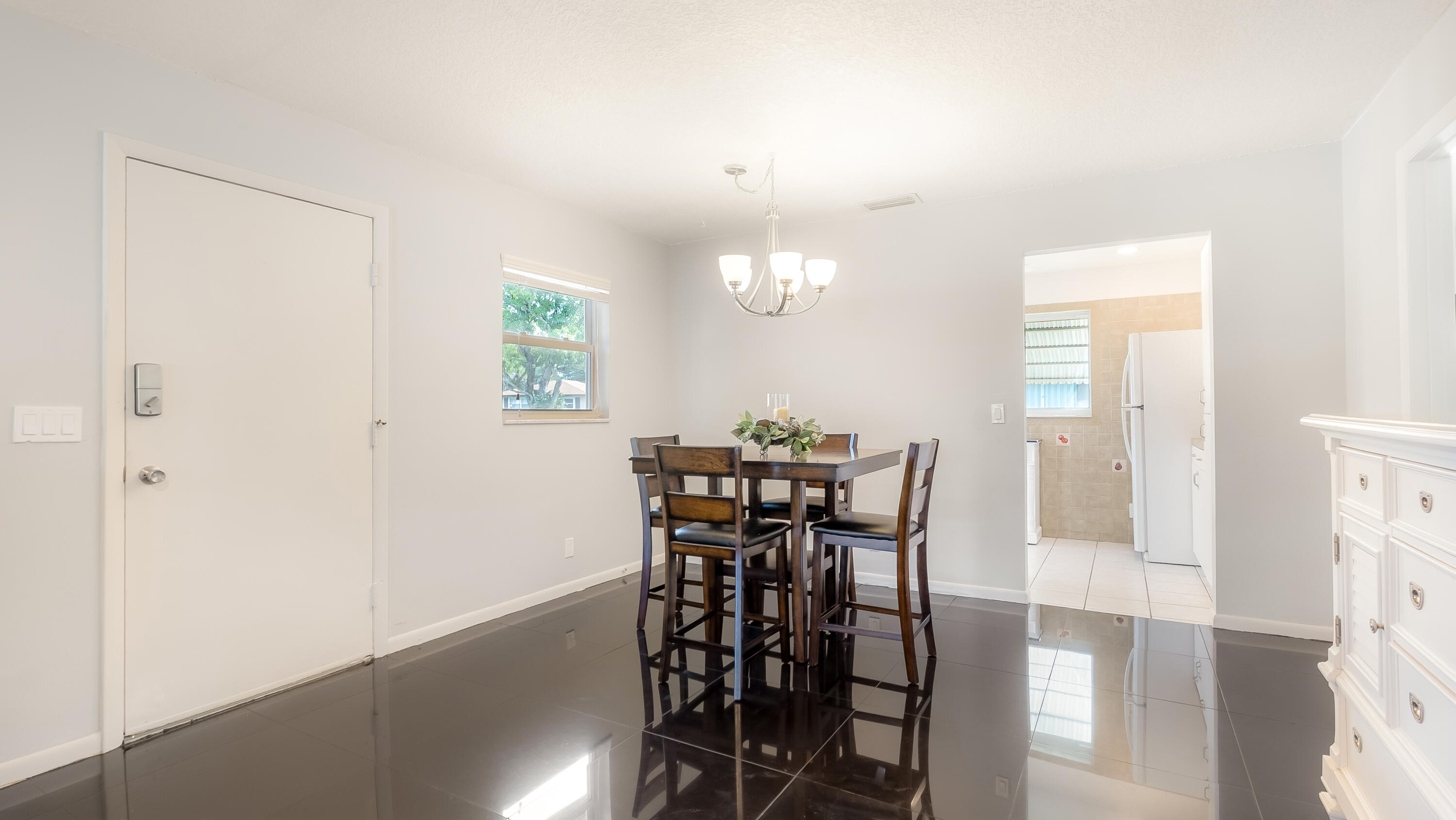 131 Mockingbird Lane Delray Beach, FL 33445 - Photo 7 of 29 a view of a dining room with furniture and wooden floor