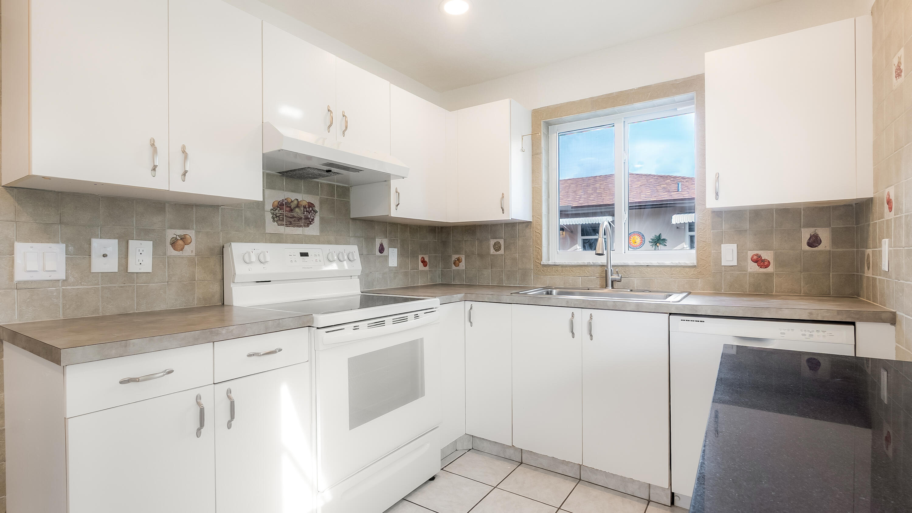 131 Mockingbird Lane Delray Beach, FL 33445 - Photo 8 of 29 a kitchen with cabinets appliances and a counter top space