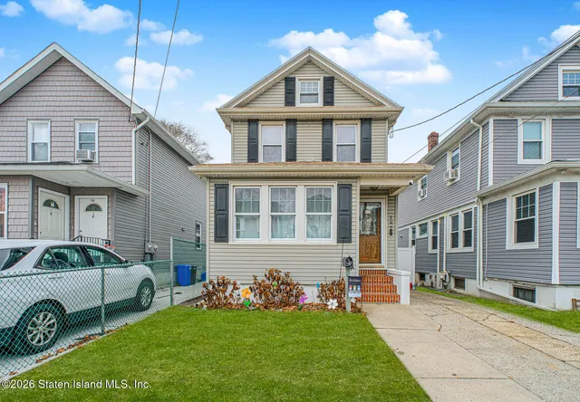 a front view of a house with a garden