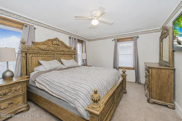 a bedroom with a bed and a small dresser