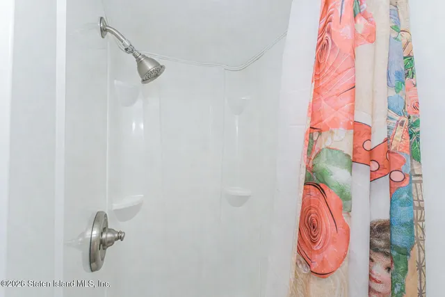 a spacious bedroom with a bed a desk and chair