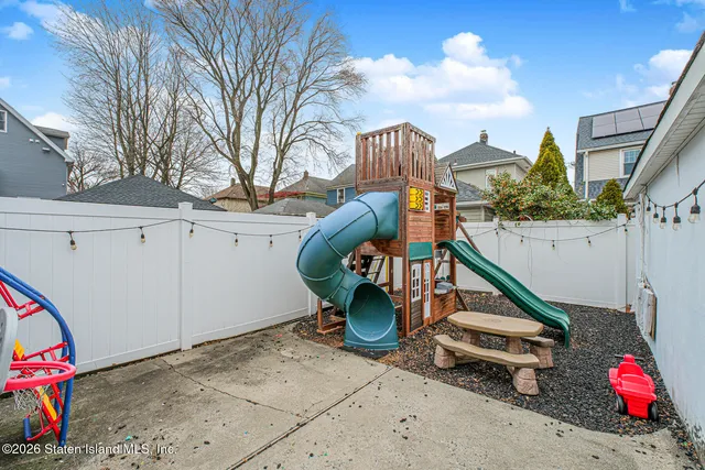 a backyard of a house with table and chairs