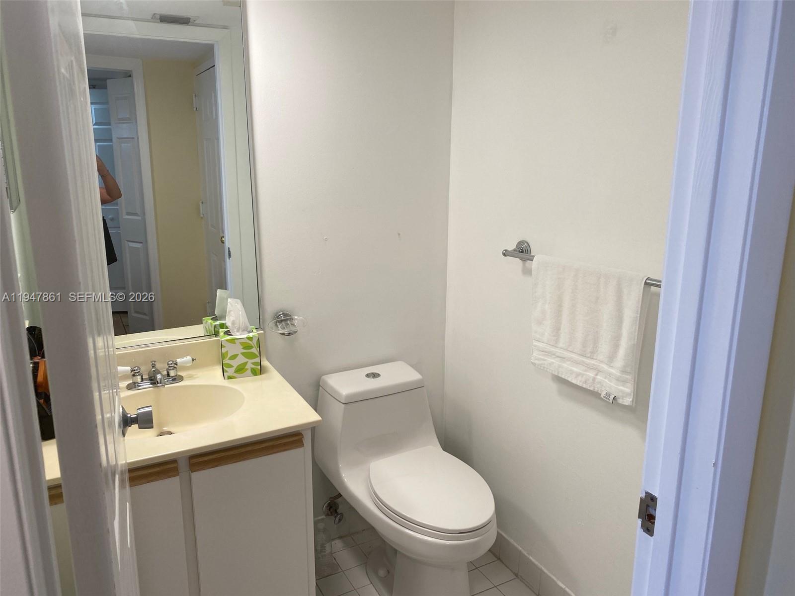 540 Brickell Key Drive, Unit 705 Miami, FL 33131 - Photo 11 of 38 a bathroom with a toilet sink and mirror