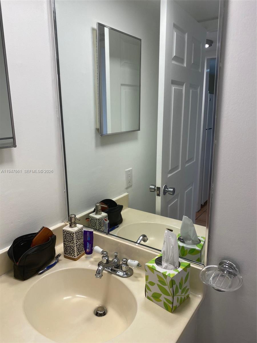 540 Brickell Key Drive, Unit 705 Miami, FL 33131 - Photo 12 of 38 a bathroom with a sink and a mirror
