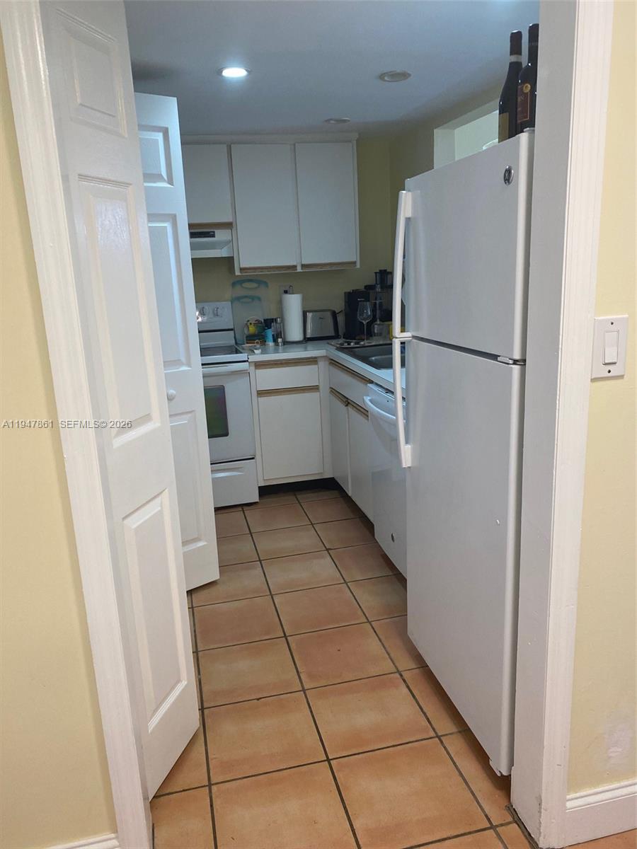540 Brickell Key Drive, Unit 705 Miami, FL 33131 - Photo 13 of 38 a kitchen with a refrigerator a sink and a stove top oven
