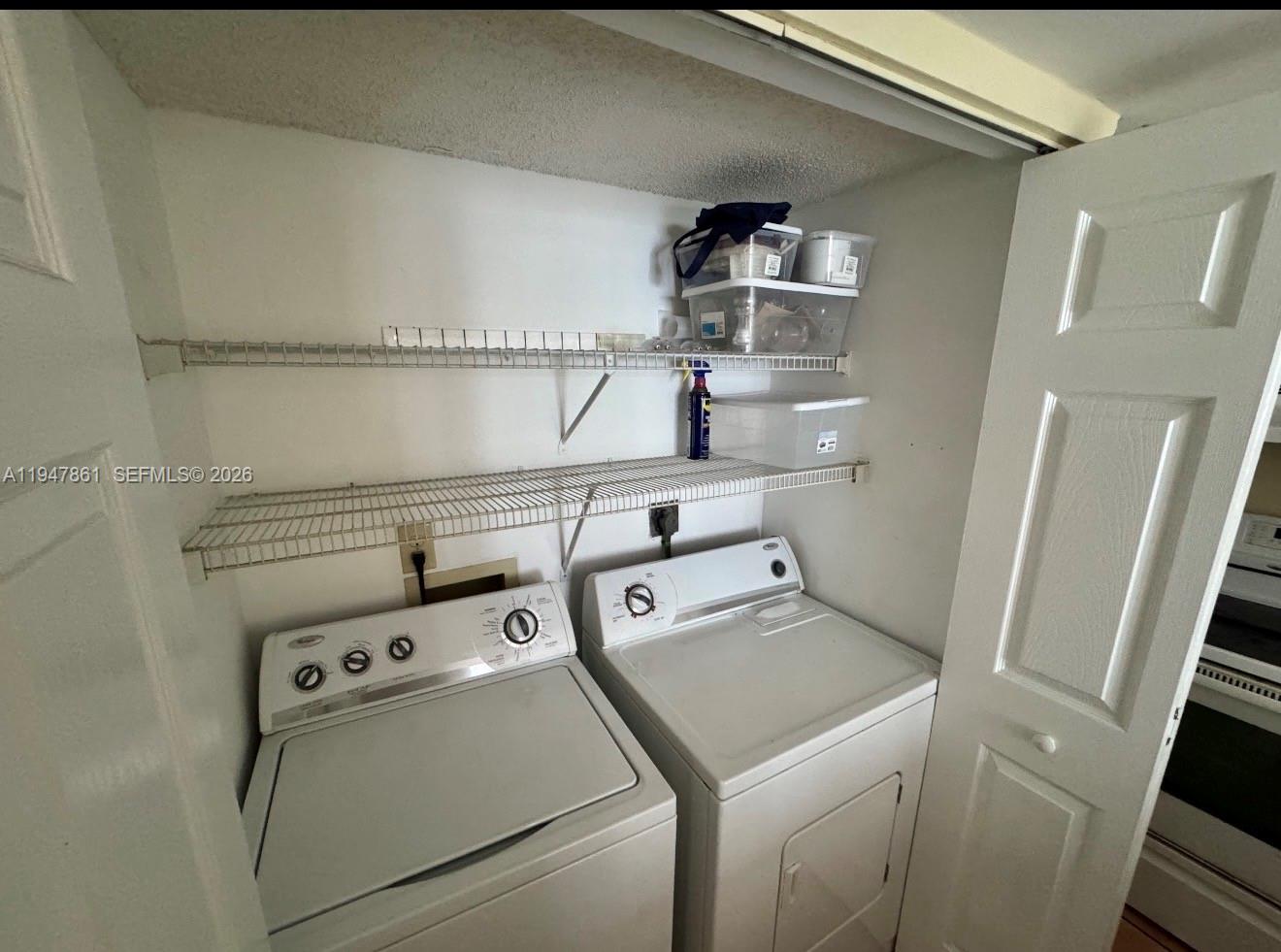 540 Brickell Key Drive, Unit 705 Miami, FL 33131 - Photo 14 of 38 a utility room with dryer and washer