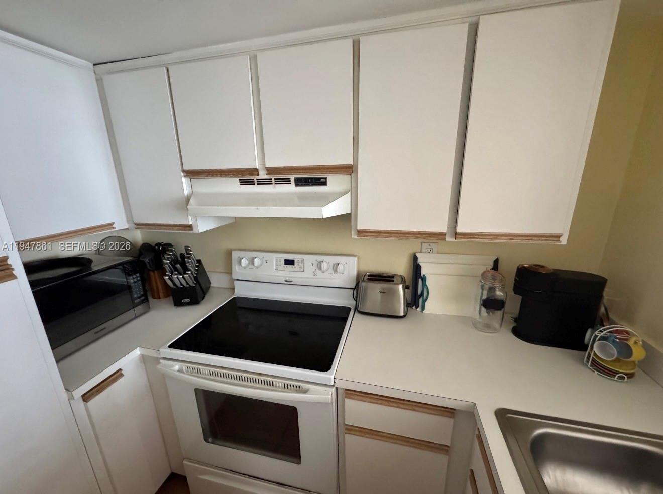 540 Brickell Key Drive, Unit 705 Miami, FL 33131 - Photo 16 of 38 a view of a storage and utility room with washer and dryer