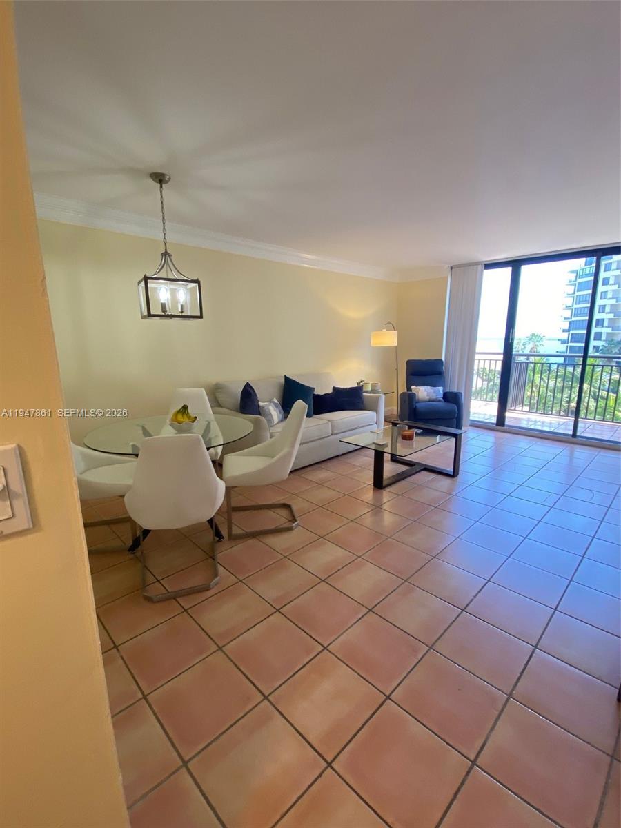 540 Brickell Key Drive, Unit 705 Miami, FL 33131 - Photo 19 of 38 a living room with a couch and a table with wooden floor