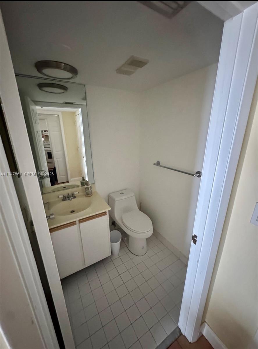 540 Brickell Key Drive, Unit 705 Miami, FL 33131 - Photo 20 of 38 a bathroom with a toilet sink and mirror