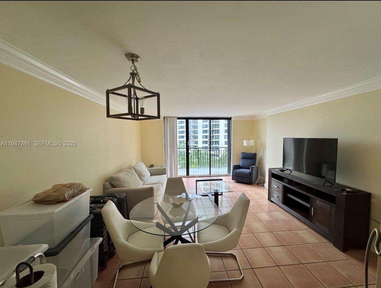 540 Brickell Key Drive, Unit 705 Miami, FL 33131 - Photo 22 of 38 a living room with furniture a flat screen tv and a window