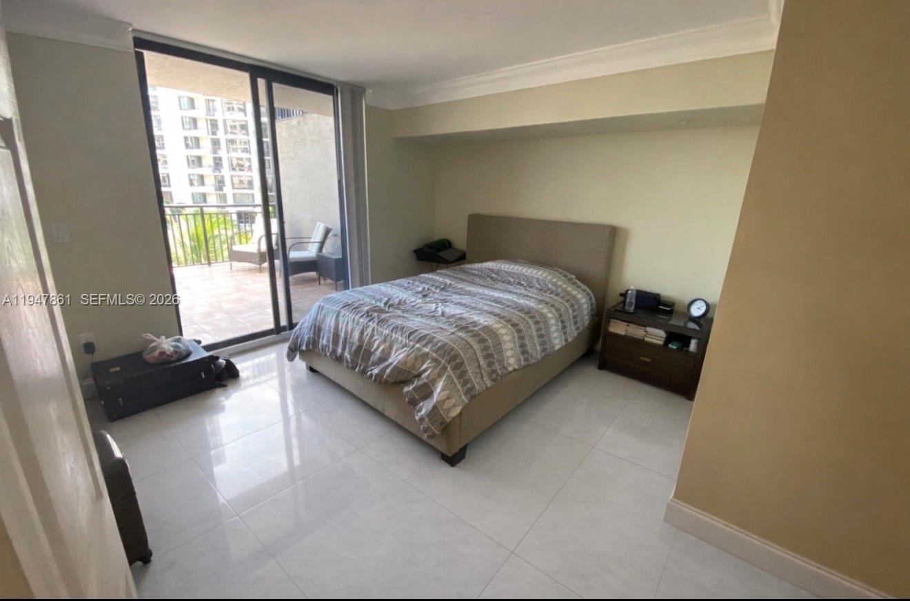 540 Brickell Key Drive, Unit 705 Miami, FL 33131 - Photo 30 of 38 a bedroom with a bed and a couch