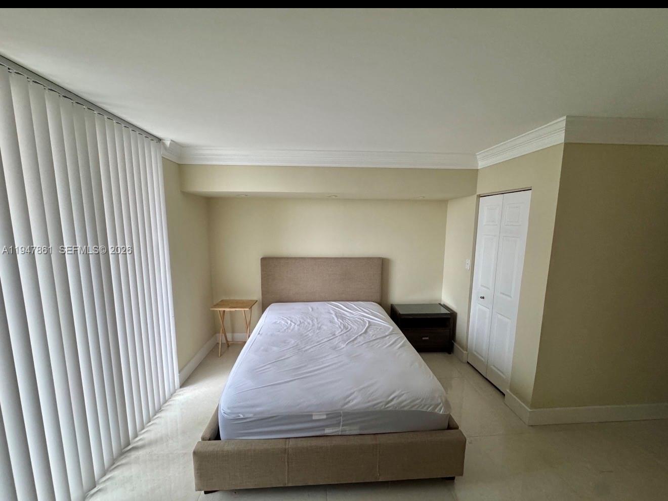 540 Brickell Key Drive, Unit 705 Miami, FL 33131 - Photo 32 of 38 a bedroom with a bed and wooden floor