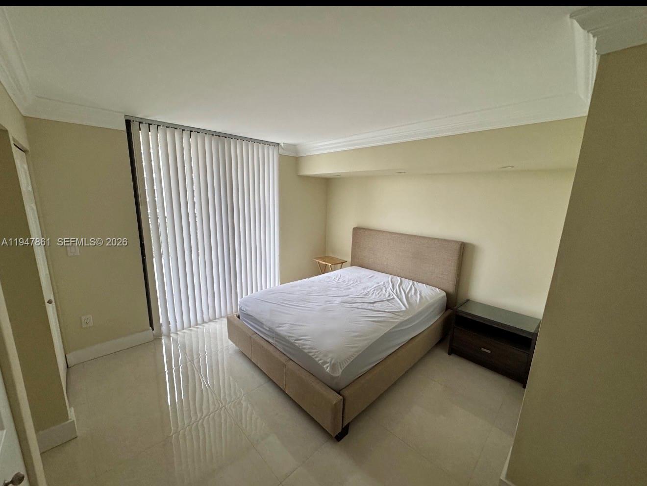 540 Brickell Key Drive, Unit 705 Miami, FL 33131 - Photo 34 of 38 a bedroom with a bed and wooden floor
