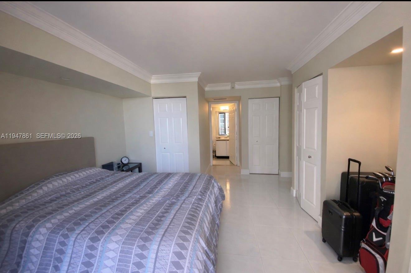 540 Brickell Key Drive, Unit 705 Miami, FL 33131 - Photo 35 of 38 a bedroom with a bed and wooden floor