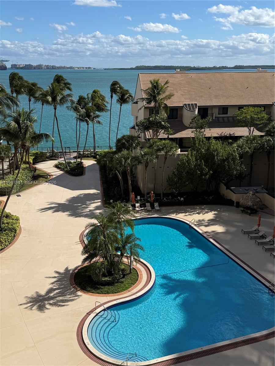 540 Brickell Key Drive, Unit 705 Miami, FL 33131 - Photo 36 of 38 a view of a swimming pool with an outdoor seating