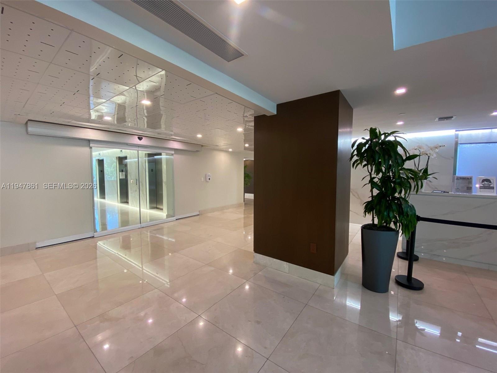 540 Brickell Key Drive, Unit 705 Miami, FL 33131 - Photo 6 of 38 a view of an empty room with a potted plant