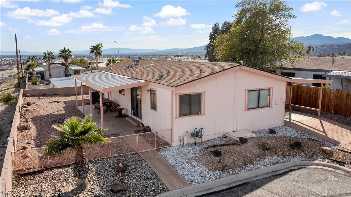 1609 Cajon Court Laughlin, NV 89029 - Photo 58 of 69 View of front facade featuring a fenced backyard, a mountain view, a patio, and roof with shingles