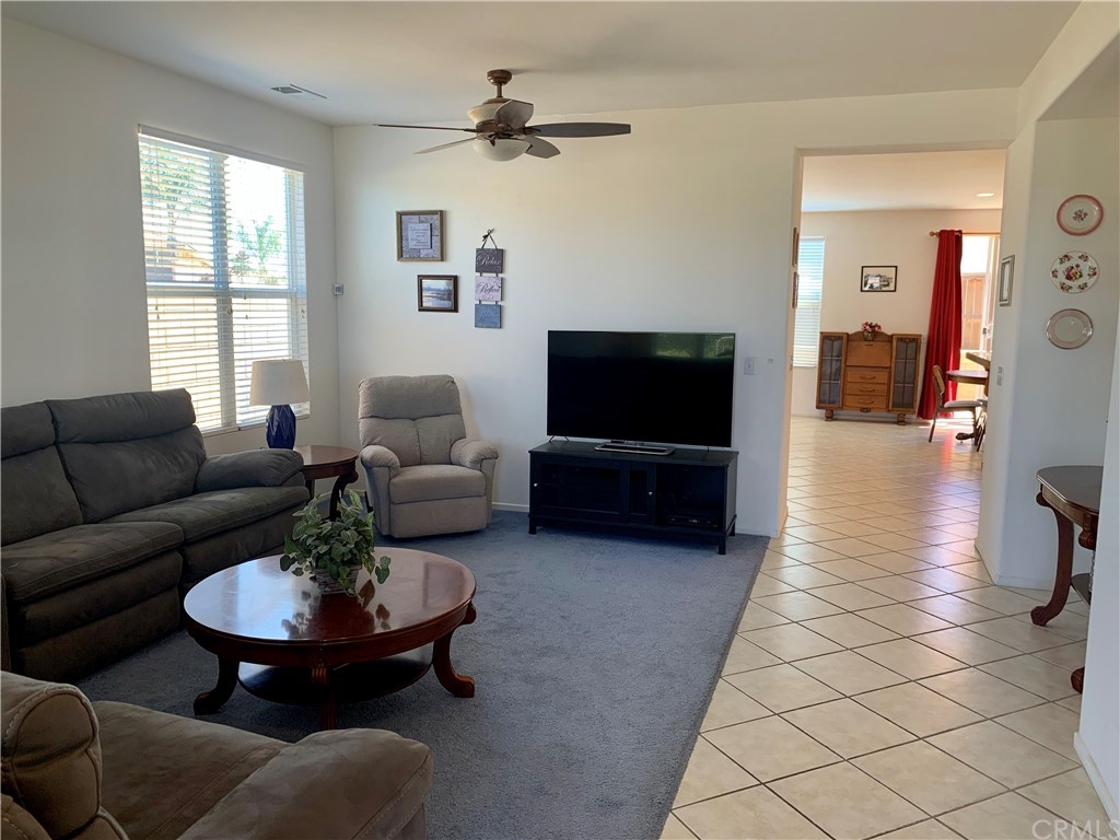 24817 Butterchurn Road Wildomar, CA 92595 - Photo 13 of 39 Since the sellers didn't need two separate living areas (this home was more space than they needed!) they used the areas for an extra large living room and an extra large dining room. There's even an exercise area in this room (see other photo).