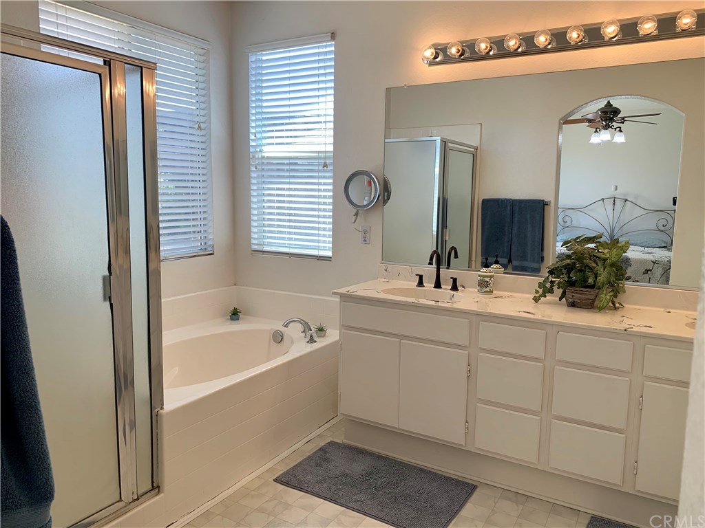 24817 Butterchurn Road Wildomar, CA 92595 - Photo 16 of 39 Extra large master bath with dual sink vanity, large oval tub, and lots of counter and cabinet space.
